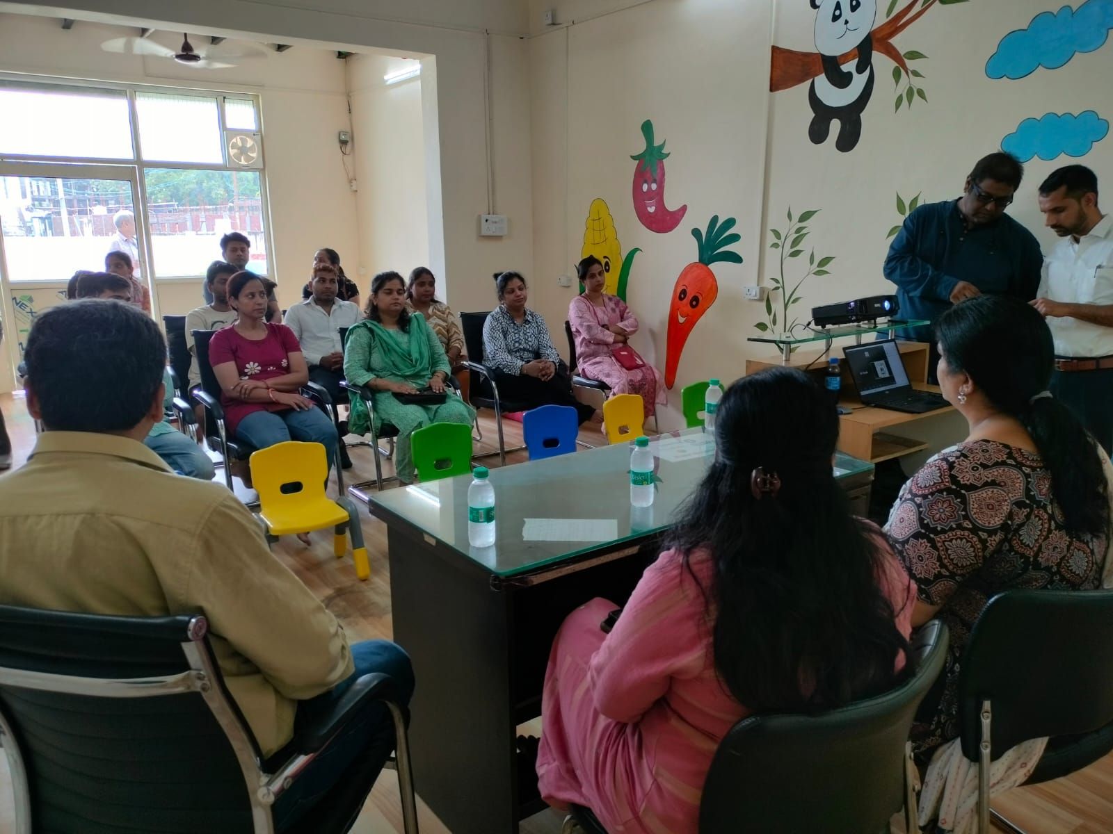 Parents seated together during a parent orientation and consultation session at the Centre.